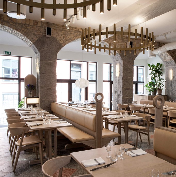 Aamanns 1921 restaurant with wooden tables and seating crafted with Sørensen Leather.