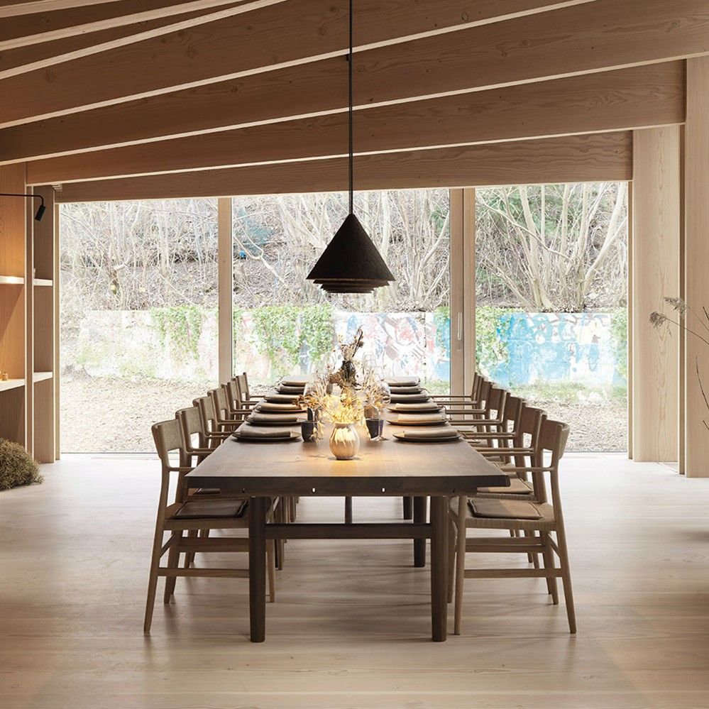 Long restaurant table with wooden chairs featuring cushions crafted with Sørensen Leather