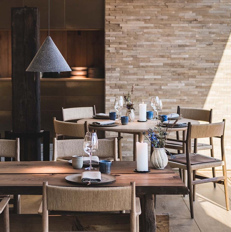 Restaurant setting with oak chairs and cushions crafted Sørensen Leather Dunes