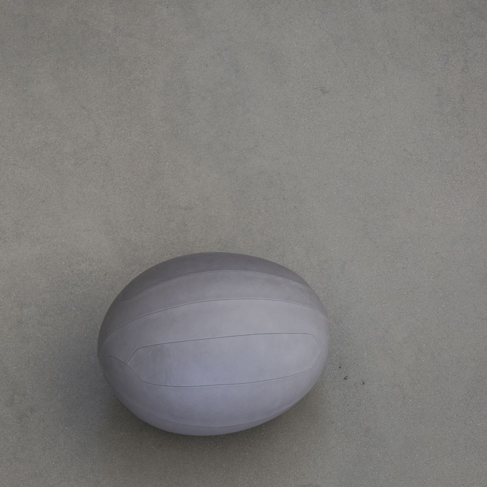 An oval ball in NUANCE leather on a concrete floor