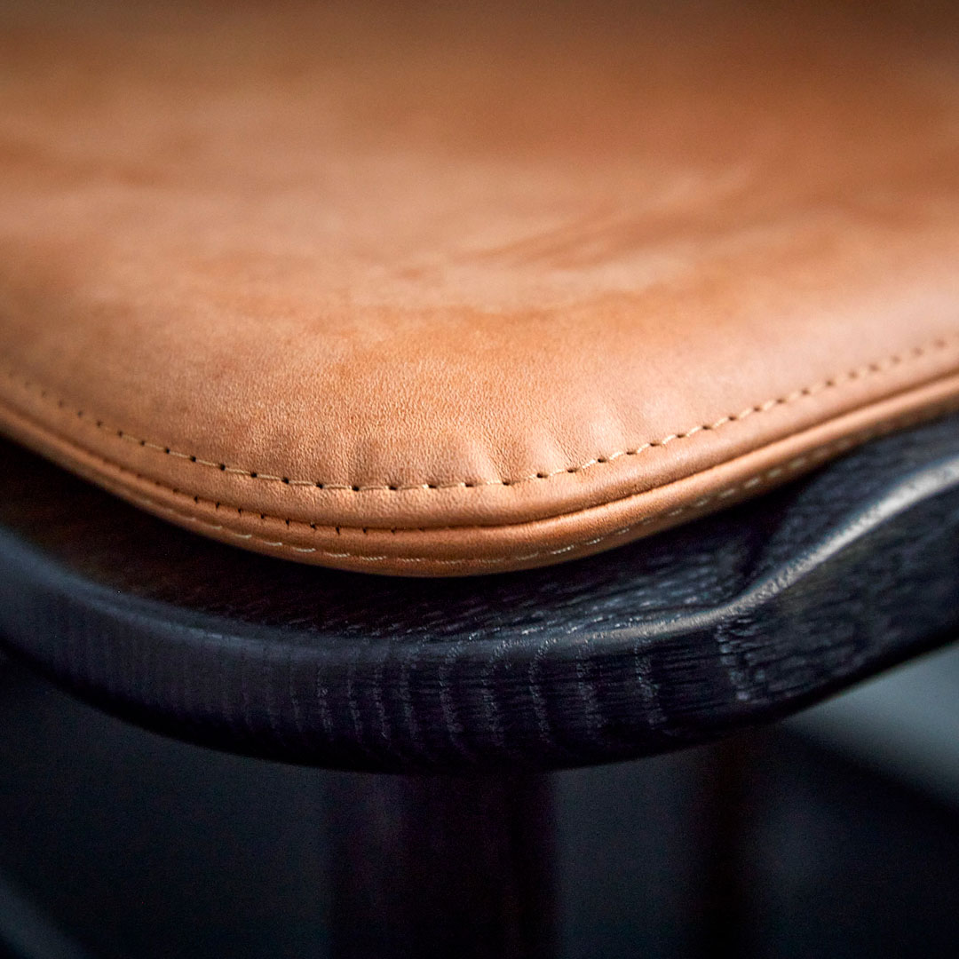 Close-up of MG101 Dining chair with a cushion crafted with leather designed by Space Copenhagen for Malte Gormsen. Photo by Magnus Omme.